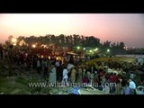 People performing Durga Puja rituals on ghat