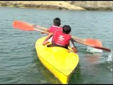 Kids canoeing paddling with a double-bladed paddle