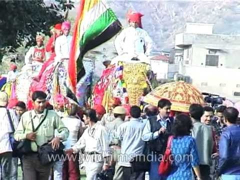 Mahouts (elephant riders) parade elephants for celebrating Holi
