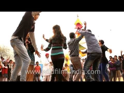 Women dancing to folk tunes at Surajkund International Crafts Mela 2013