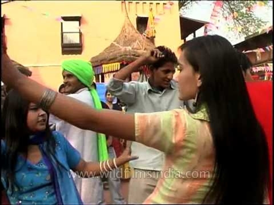 Visitors join in dancing with folk dancers at 27th Surajkund International Crafts Mela