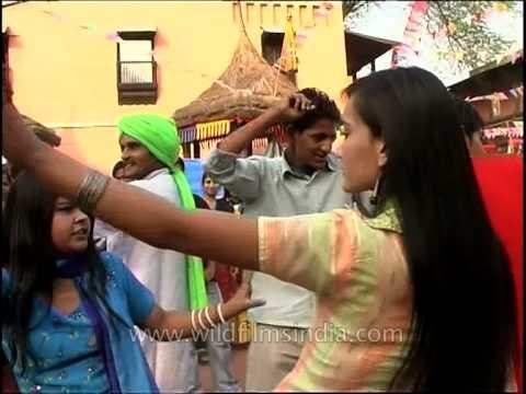 Visitors join in dancing with folk dancers at 27th Surajkund International Crafts Mela