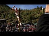American participating in the greased pole climbing competition, Hornbill Festival