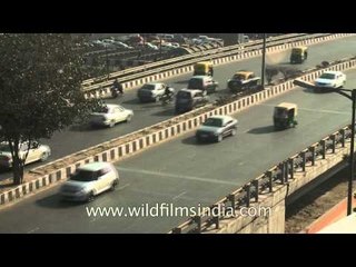 Smooth traffic moving alongside the violet line metro track near Lajpat Nagar