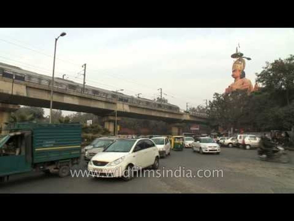 Huge statue of Lord Hanuman amid traffic and metro line - Karol Bagh, Delhi