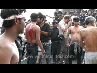Old man flogging himself with sharp metal blades on Muharram