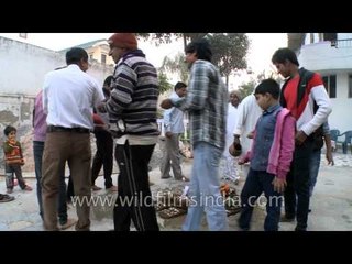 Showering kheel on Govardhan puja fire