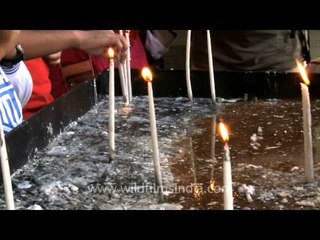 Lighting candles at Basilica of Bom Jesus, Goa