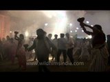 Devotees dance whilst holding aartis on Durga Puja