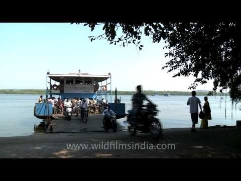 Bikes and passengers getting off a ferryboat in Goa