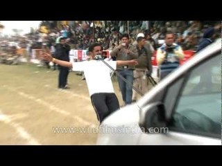 Young man pulling a car with his teeth!