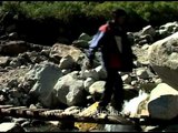 Students cross a wooden bridge during a school trip