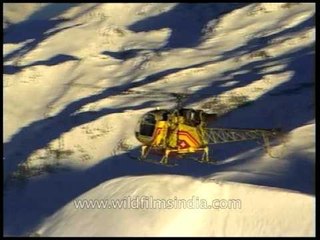 Swiss helicopter lands on a snowy Himalayan mountain-top
