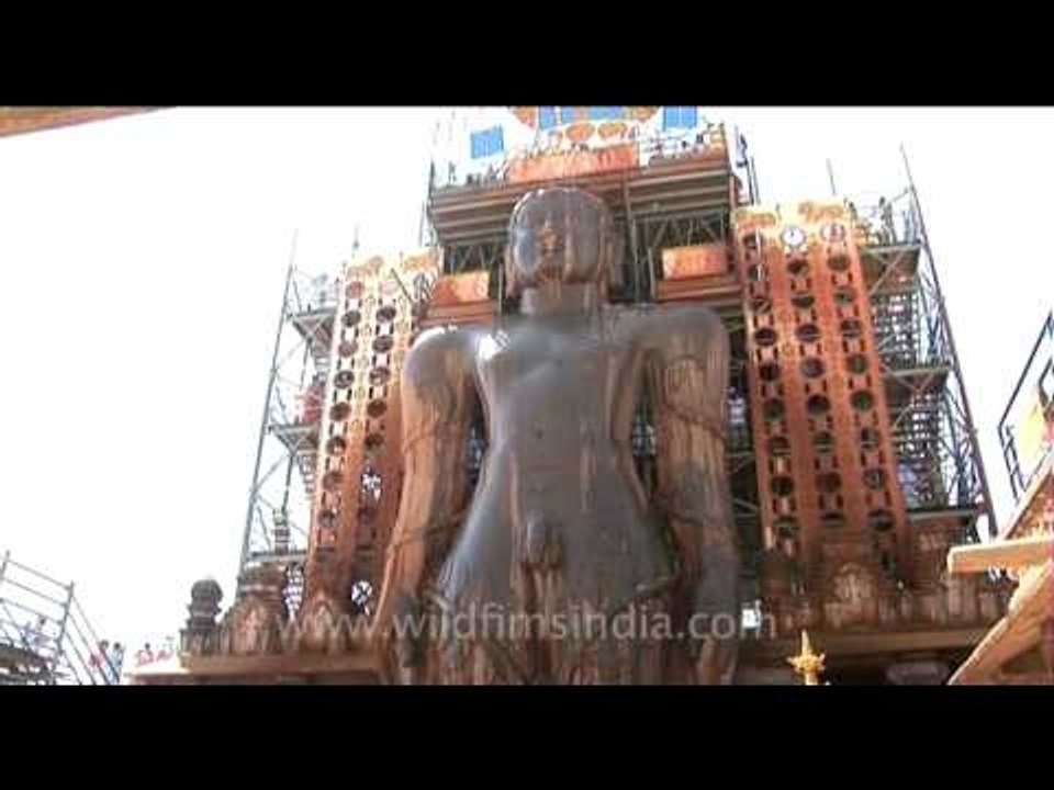 Pouring offerings over lord Bahubali's gigantic statue, Sharavanbelagola