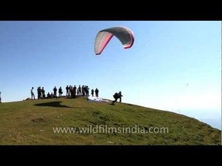 Man parasailing under blue sky