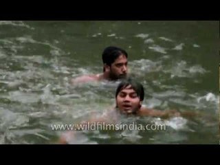 Young boys swimming in the step-well of Nizamuddin