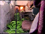 Shaping bangles at workshop in India