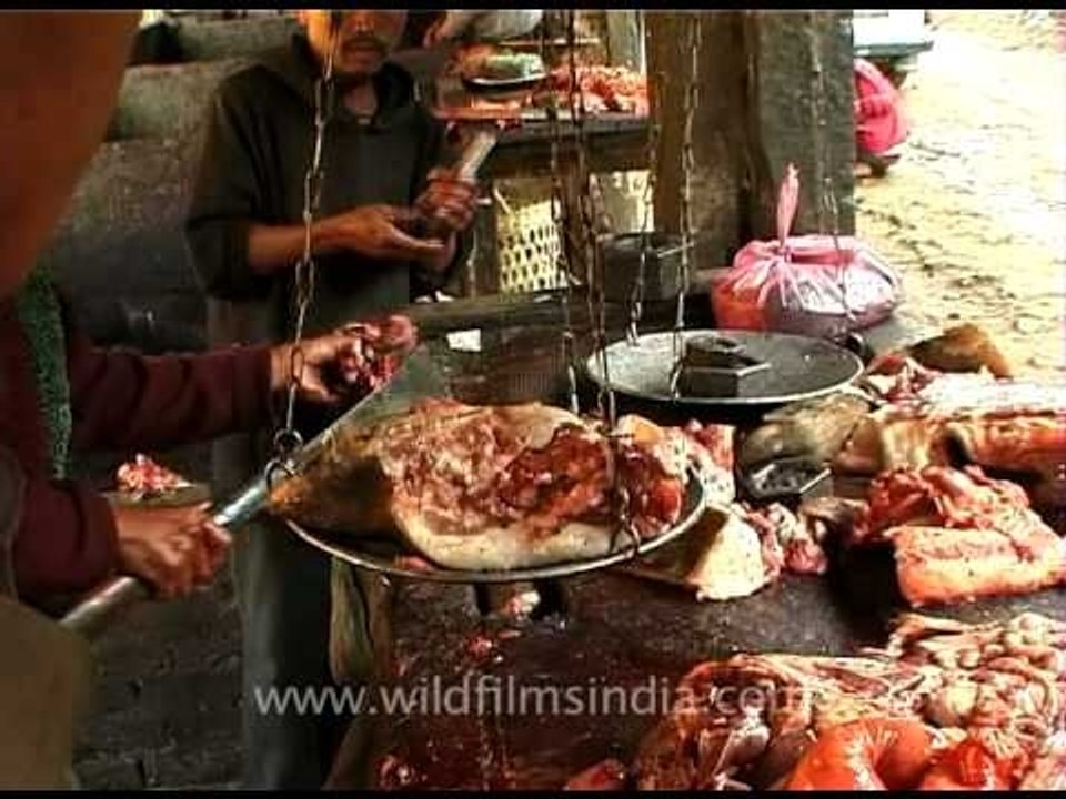 Butcher chops the pig into peices