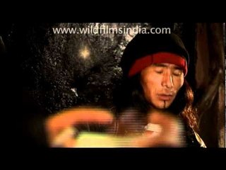 Tibetan playing guitar and singing in a cafe