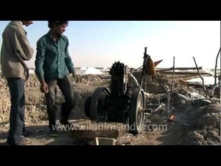 Struggling with an antique pump to draw ground water...