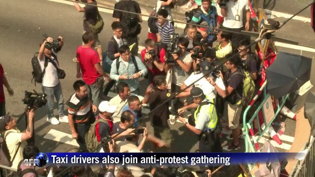 Clashes as masked men rush Hong Kong protest barricades