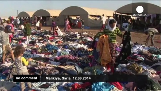 Exhausted Yazidis fleeing militants reach refugee camp in Syria