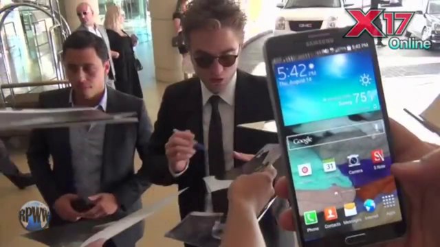 Robert Pattinson Signing for Fans Outside the Beverly Hilton Before the HFPA Charity Dinner