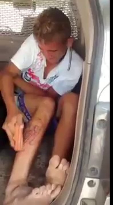 Gang member erasing tattoo using sandpaper