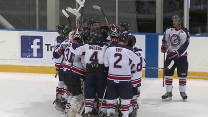 Hockey player celebrates goal by sliding across the ice on his head