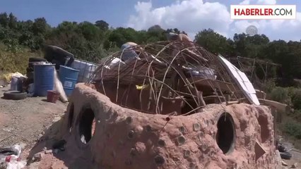 Araba lastiği, şişe ve kilden ev -