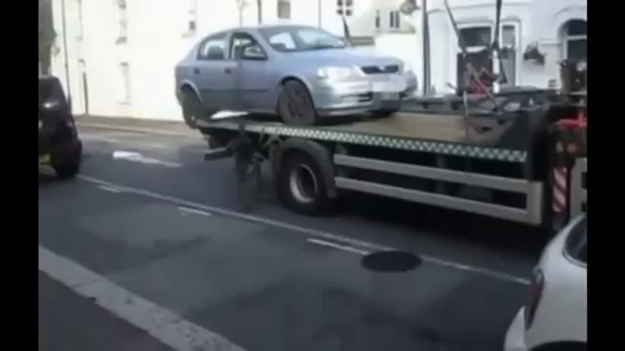 Motorist stops car being impounded by reversing it off tow truck