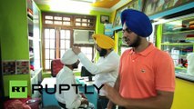 India: Turban-meister! See man wrap turban on moving motorcycle