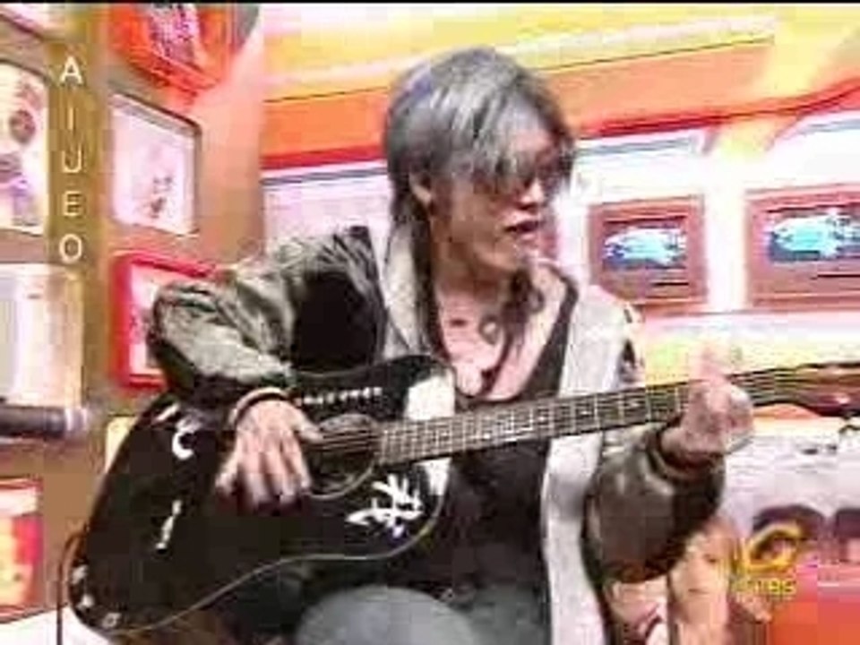 Playing his guitar!