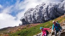 Climbers film as they are covered by ash cloud on an erupting volcano Mount Ontake