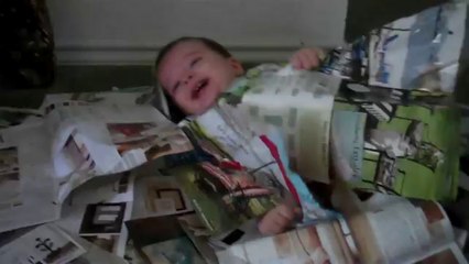 funny-Baby having fun tearing up a magazine