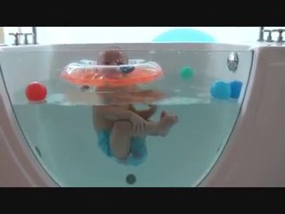 Triplets' first swimming lesson