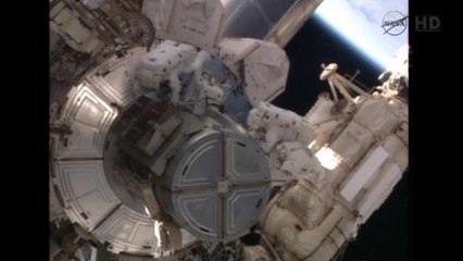 Astronauts take first walk outside International Space Station
