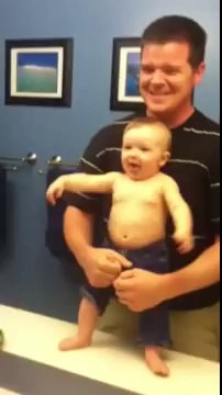 Baby Adorably Flexes Muscles With Dad