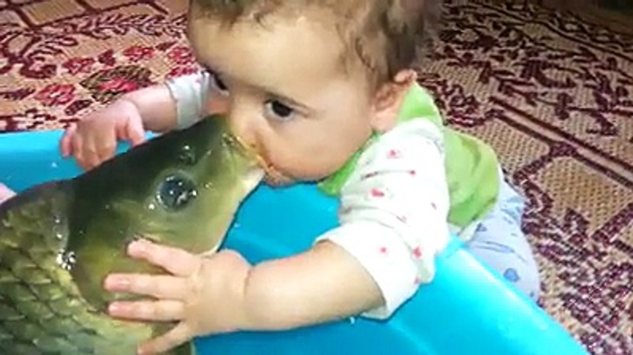 Baby Kissing A Fish
