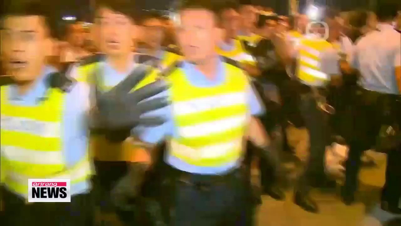 Police, protesters clash in Hong Kong; officers...