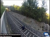 Italian teen lays between tracks and lets speeding train race over him
