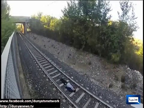 Italian teen lays between tracks and lets speeding train race over him