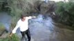 Drunk Portuguese guy tries to cross a river by bike
