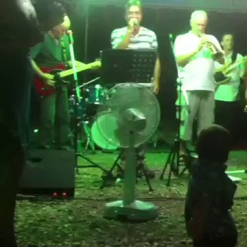 Singing a baby kid is dancing.