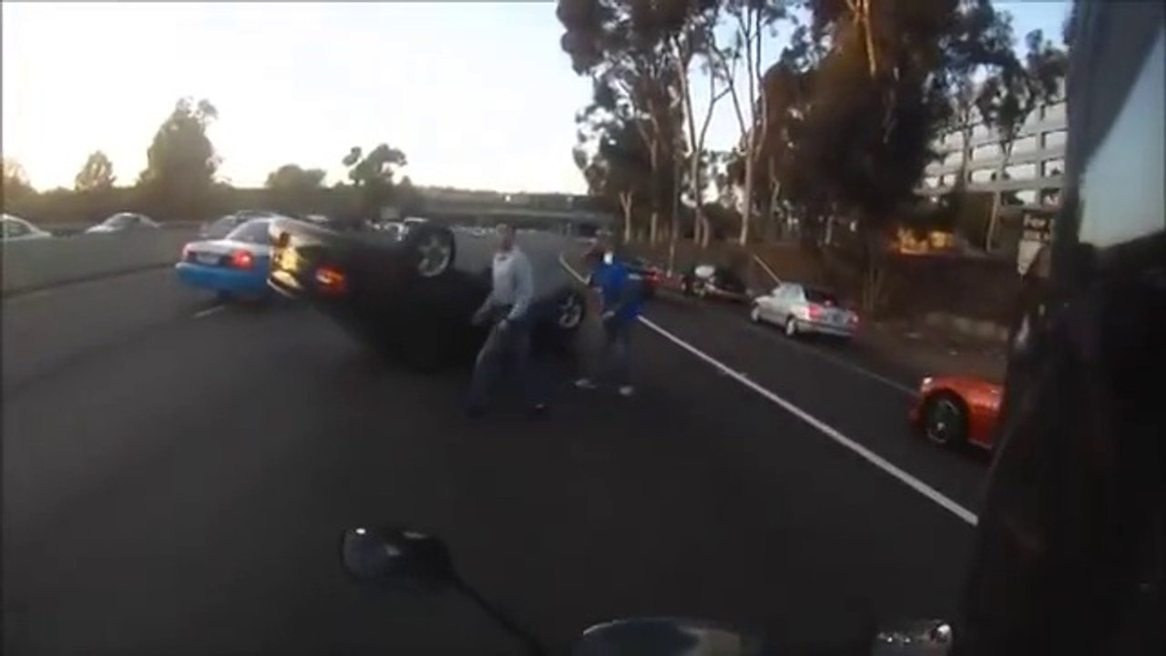 Motorcyclist Frees Woman From Overturned Car
