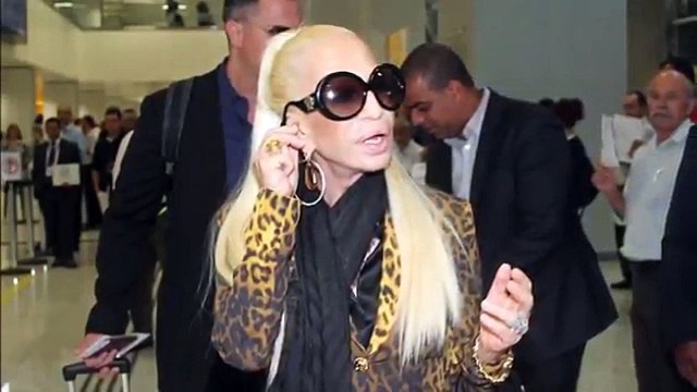 Donatella Versace arrives in São Paulo looking ready to melt as she shows off her VERY shiny face