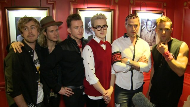 McBusted: Dougie plays air guitar and Harry grabs a reporter