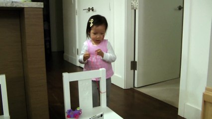 Girl Trying To Tie With A String