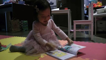 Girl Reading Sesame Street Book
