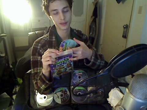 Xbox 360 And PlayStation 3 Video Games Being Organized Into A DVD/CD Travel Case In Real Life